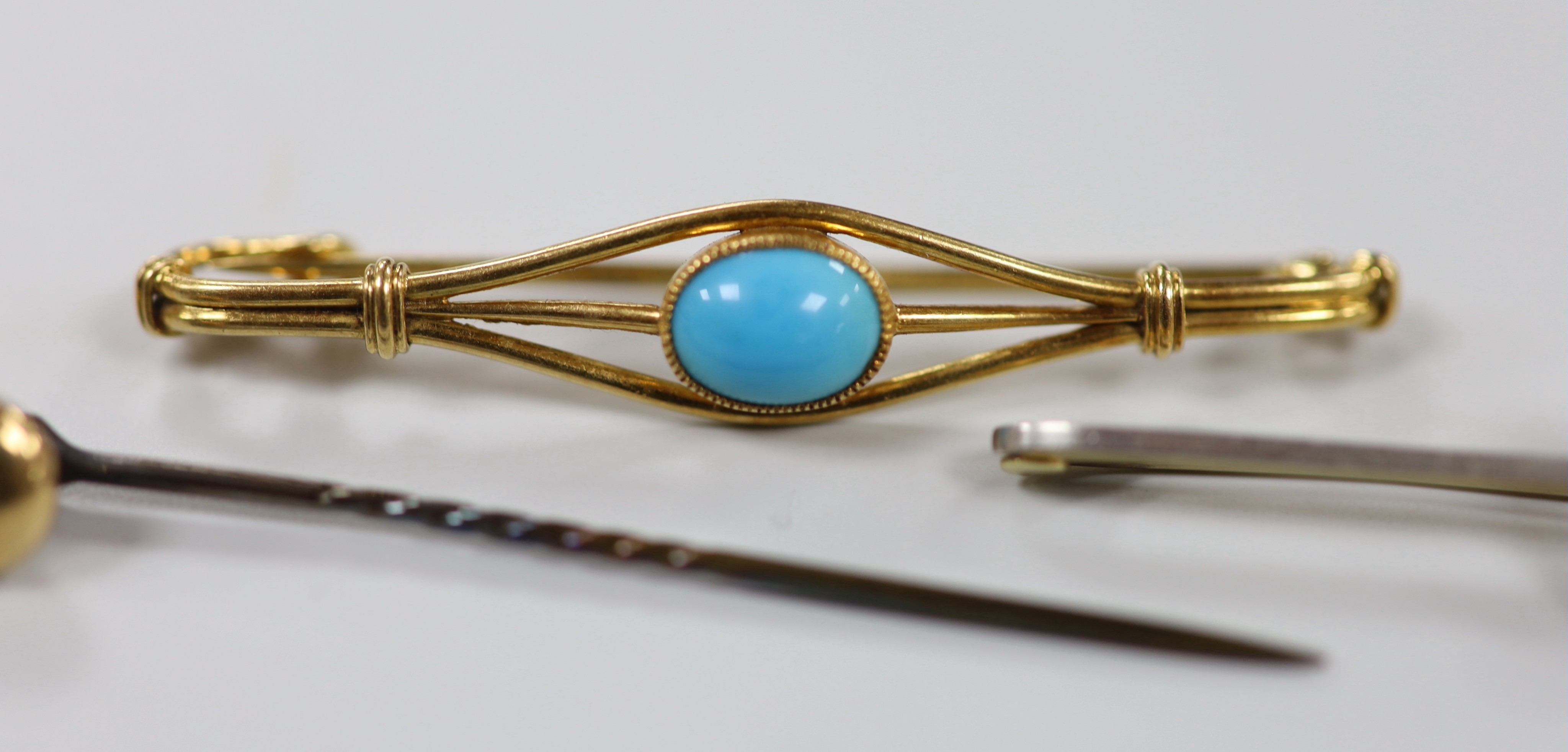 An Edwardian 15ct and single stone aquamarine set bar brooch, 58mm, gross 3.5 grams, two other bar brooches including a 9ct & plat, white opal and diamond chip and a diamond set stick pin, gross weight 11 grams.